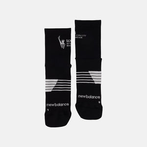 Black socks with white branding on a light gray background