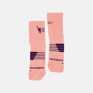 Pair of pink socks with black branding on a white background