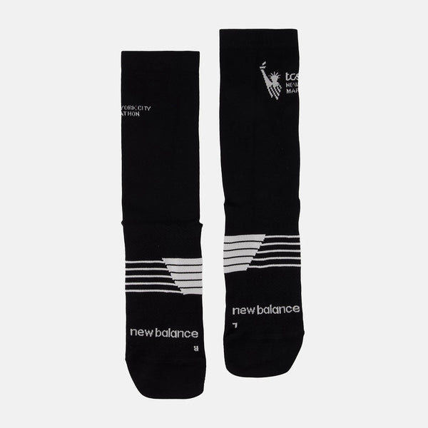 Black socks with white branding and details on a light gray background
