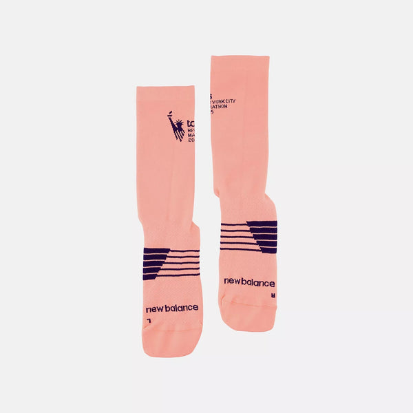 Pair of pink socks with black branding on a white background
