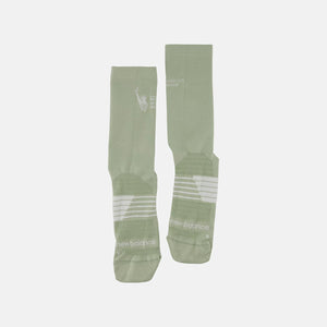 Two green socks with white text on a light gray background