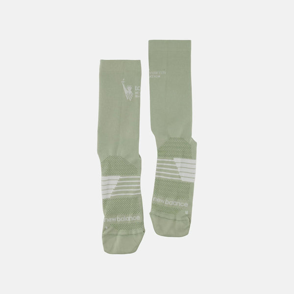 Two green socks with white text on a light gray background