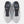 A New Balance running shoe in white, gray, and blue against a light gray background.