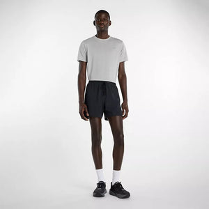 Man wearing a white t-shirt and black shorts on a white background