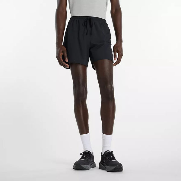 Person wearing black athletic shorts on a white background