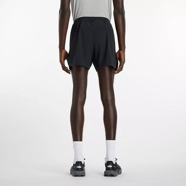 Person wearing black athletic shorts on a white background