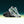 Gray running shoe with green accents on a gradient background.