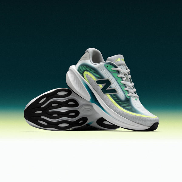 Gray running shoe with green accents on a gradient background.