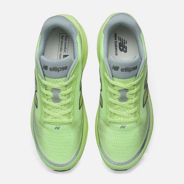 Pair of neon green running shoes with New Balance branding on a white background
