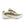 A New Balance running shoe in a metallic gold and cream colorway, featuring a prominent gold 'N' logo on the side, black laces, and a thick white and gold midsole, shown against a plain white background.
