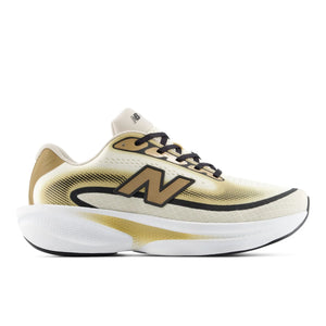 A New Balance running shoe in a metallic gold and cream colorway, featuring a prominent gold 'N' logo on the side, black laces, and a thick white and gold midsole, shown against a plain white background.