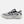 A New Balance running shoe in white, black, and gray, shown against a plain white background.