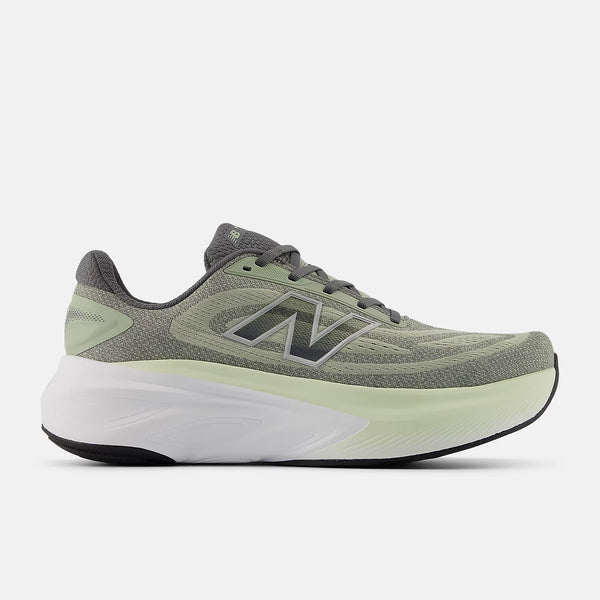 Dark green New balance running shoe with white sole on a light gray background