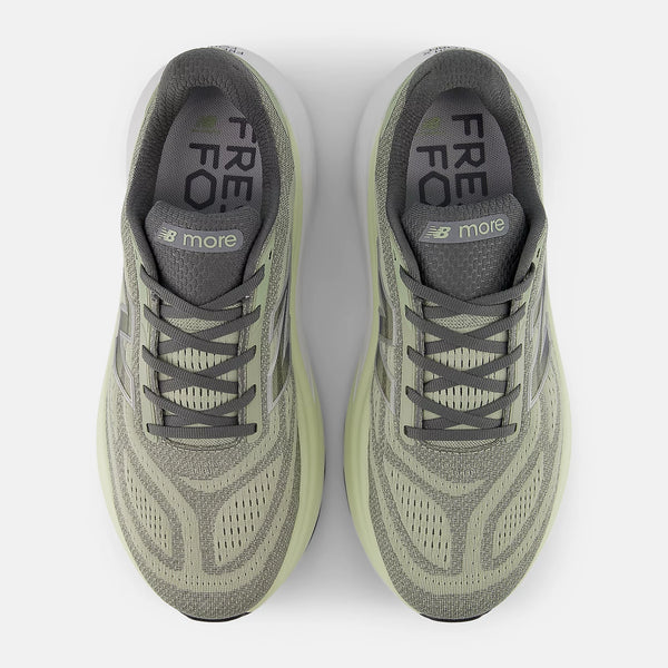 Pair of green running shoes with 'FRE' and 'more' text on a white background