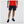 Person wearing black shorts and a red shirt on a white background