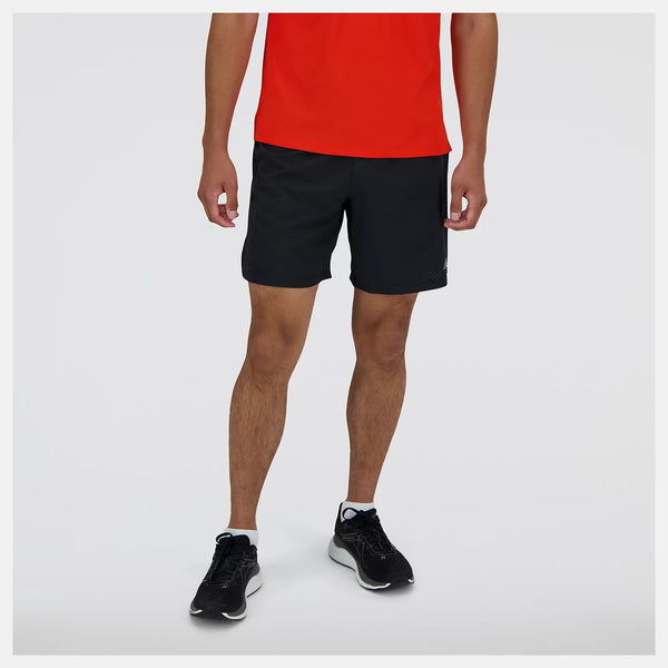 Person wearing black shorts and a red shirt on a white background