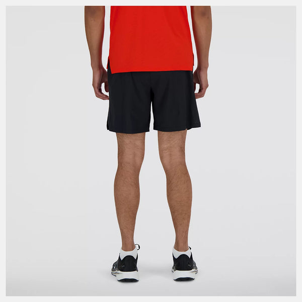 Person wearing black shorts and a red shirt on a white background