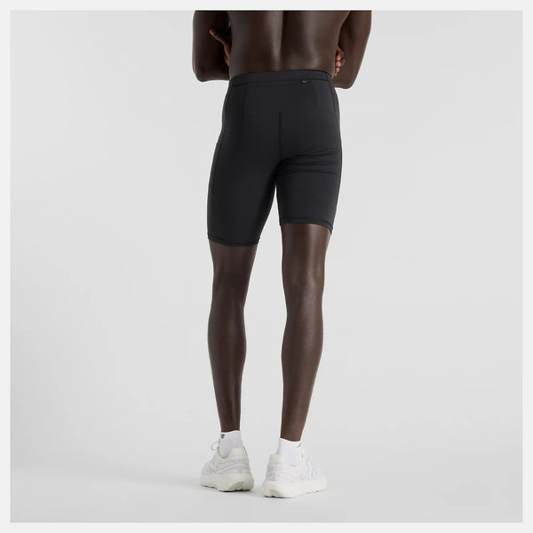 Person wearing black athletic shorts on a light gray background