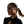 Woman wearing a black earbud with a plain background