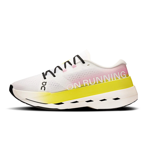 White running shoe with yellow sole on a white background