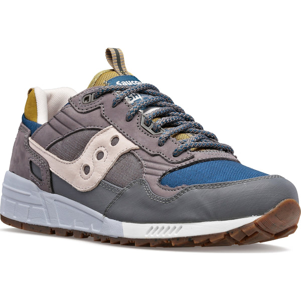 Gray and blue sneaker with brown accents on a white background