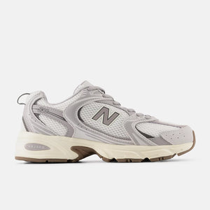 Gray sneaker with 'New Balance' branding on a white background