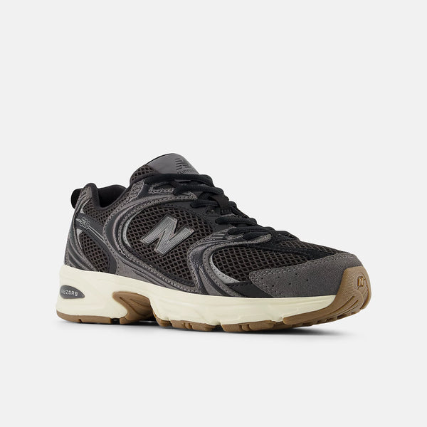Gray sneaker with brown sole on a white background