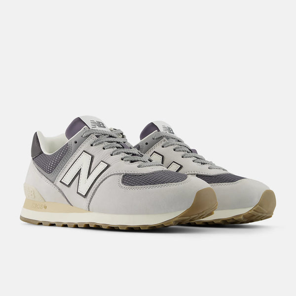 Gray sneakers with a New Balance logo on a white background