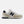 Beige and navy New Balance sneaker on a white background