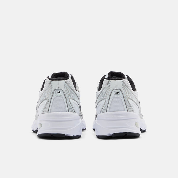 White sneakers with black accents on a white background
