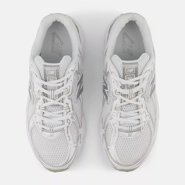Pair of white sneakers on a light gray background