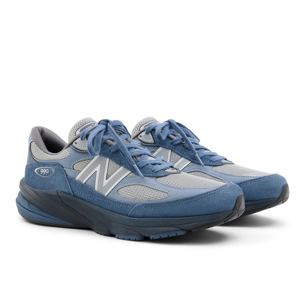 A pair of blue and gray sneakers on a white background.