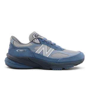 Blue and gray sneaker with New Balance logo on a white background