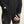 Person wearing black athletic outfit with visible brand logos on a neutral background