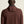 Person wearing a brown ribbed sweater against a beige background