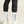 Person wearing black leggings with a visible brand logo, white socks, and white shoes on a neutral background.