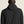 Person wearing a black jacket with a hood on a plain background