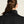 Person wearing a black turtleneck with a neutral background