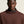 Man wearing a brown ribbed sweater against a beige background