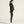 Person wearing a black outfit on a plain background