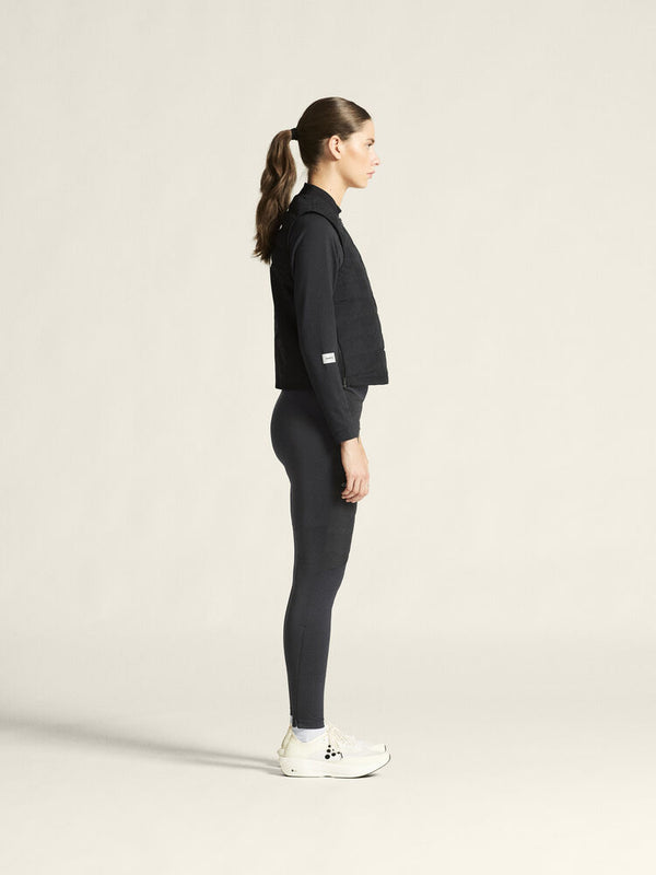 Person wearing a black outfit on a plain background
