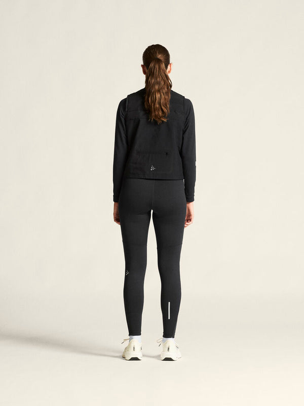 Person wearing a black outfit on a light gray background