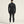 Person wearing a black athletic outfit on a light beige background