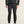 Person wearing a black puffer jacket and pants on a light background
