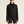 Person wearing a black sweatshirt and shorts with reflective sunglasses on a beige background