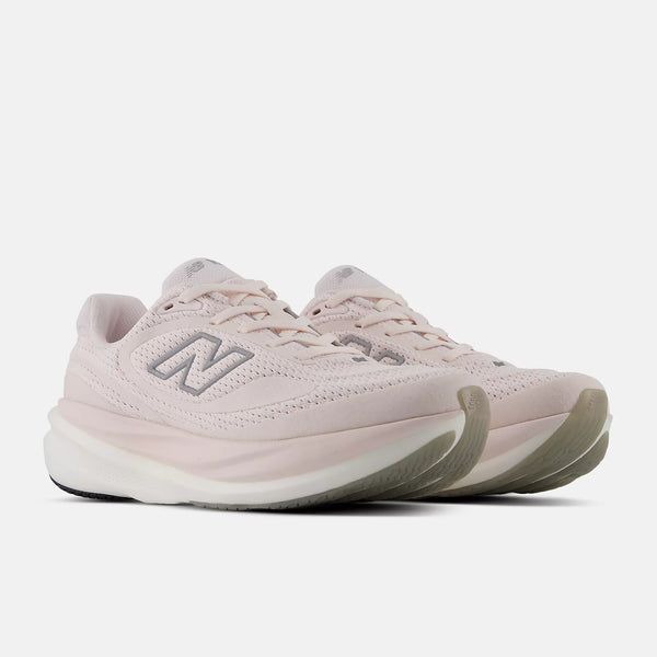 Pair of light pink New Balance sneakers on a white background