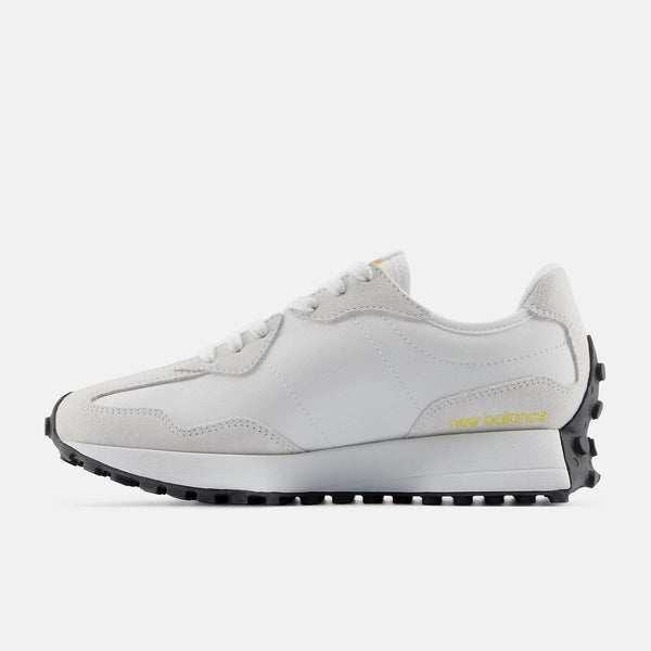 White sneaker with black sole on a white background