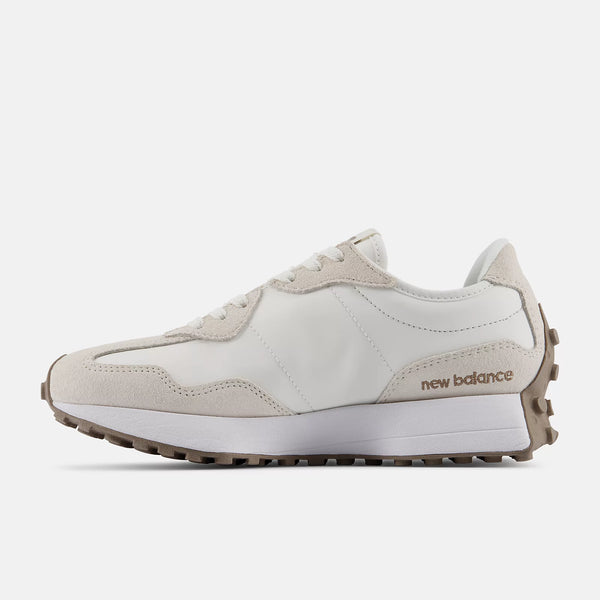 Beige sneaker with 'New Balance' branding on a white background
