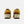 A pair of New Balance sneakers shown from the back, featuring a mustard yellow and brown suede upper with cream midsoles and white 'new balance' branding on the heel.