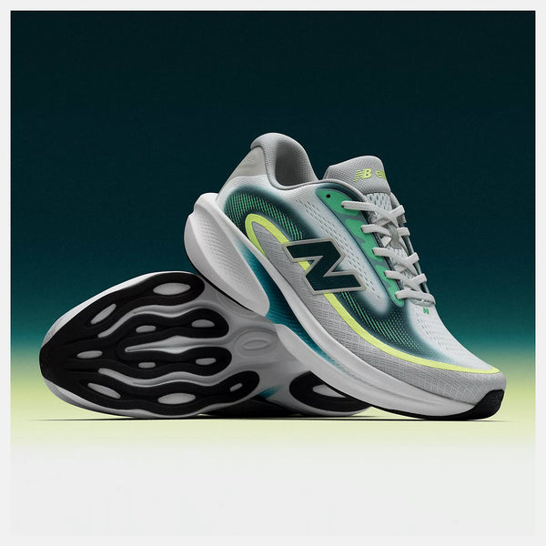 Gray running shoes with green accents on a gradient background